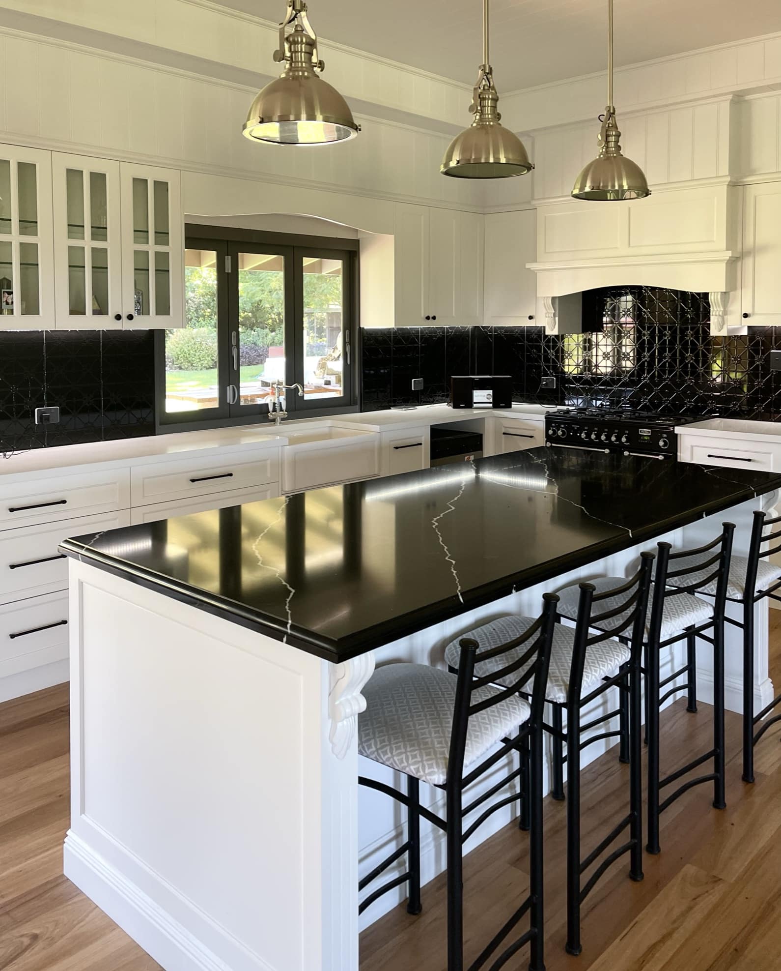 black countertop and white cabinetry custom kitchen