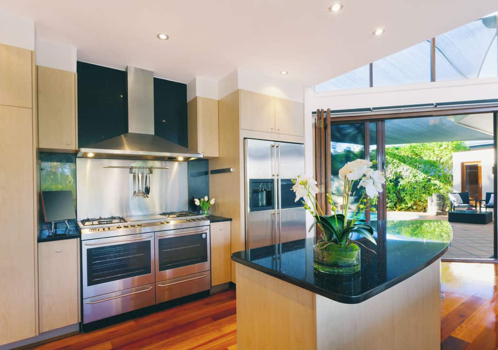 White Flowers on the Kitchen Bench — Inovative Interiors In Cardiff, NSW