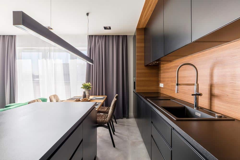 Kitchen With Dark Colored Cabinets — Inovative Interiors in Cardiff, NSW