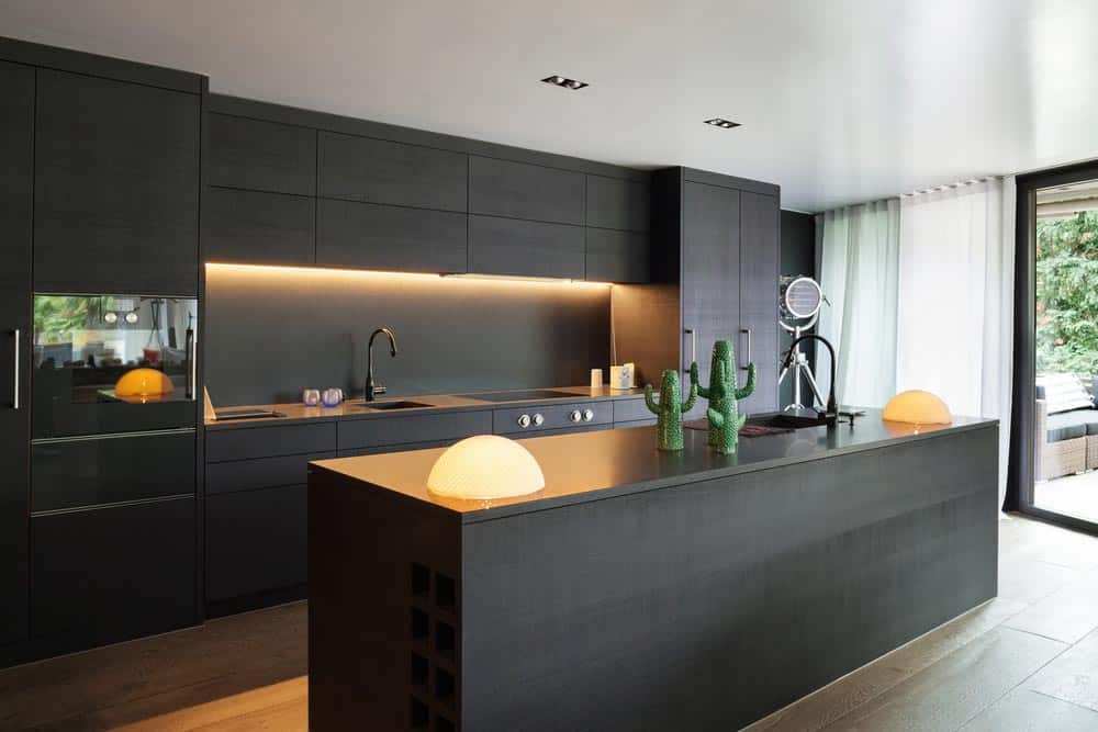 Modern Kitchen With Black Cabinets — Organised Kitchen - Inovative Interiors in Cardiff, NSW