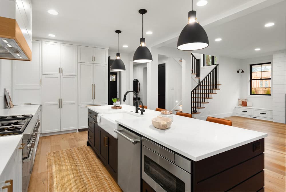 White Wooden Cabinetry In Newly Designed Kitchen